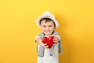 Portrait of boy with decorative heart on color background