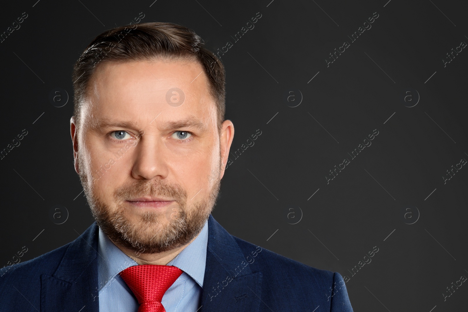 Photo of Portrait of mature man on black background