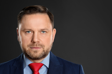 Photo of Portrait of mature man on black background