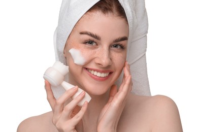 Photo of Young woman washing face with brush and cleansing foam on white background