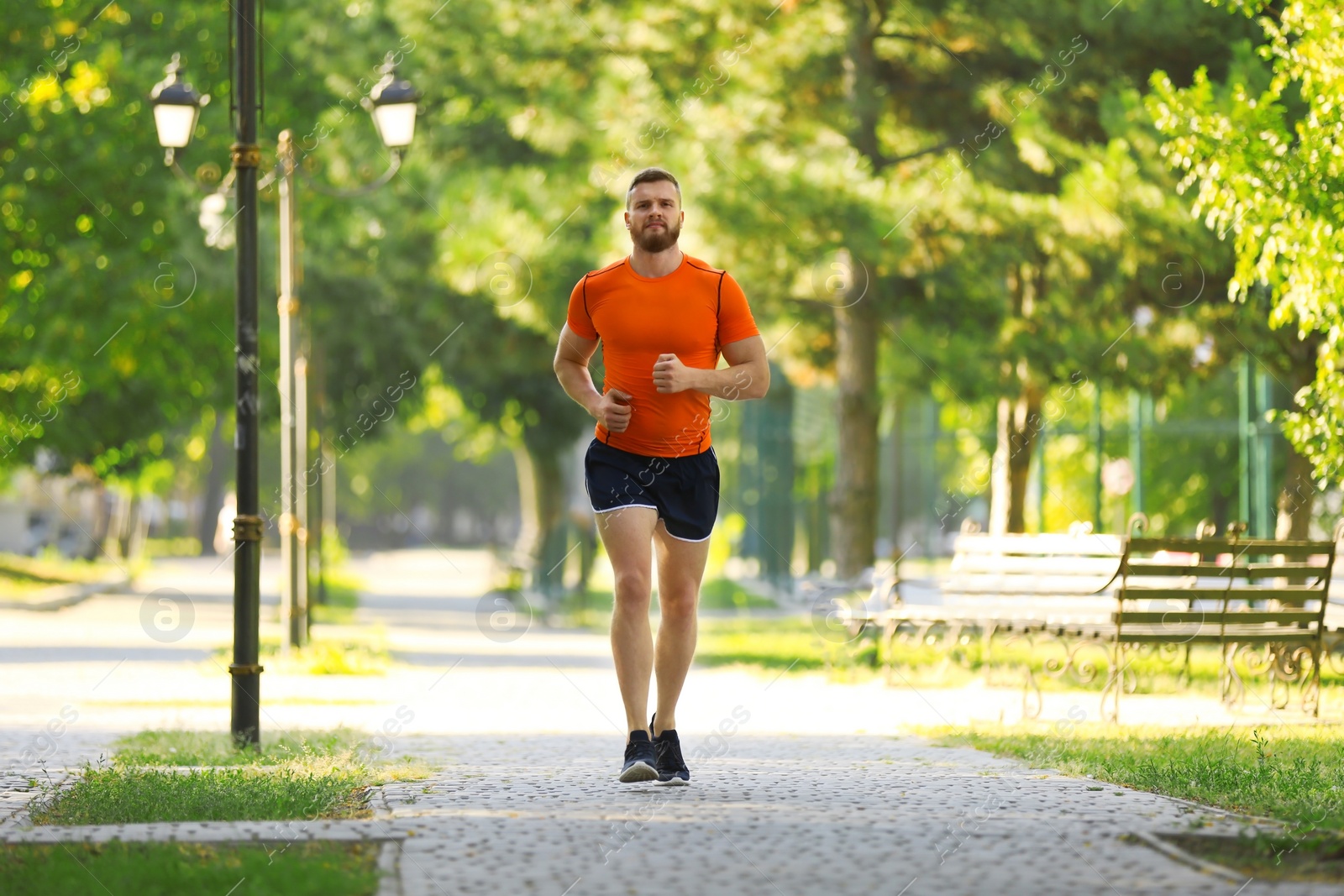 Photo of Young man running in park on sunny day