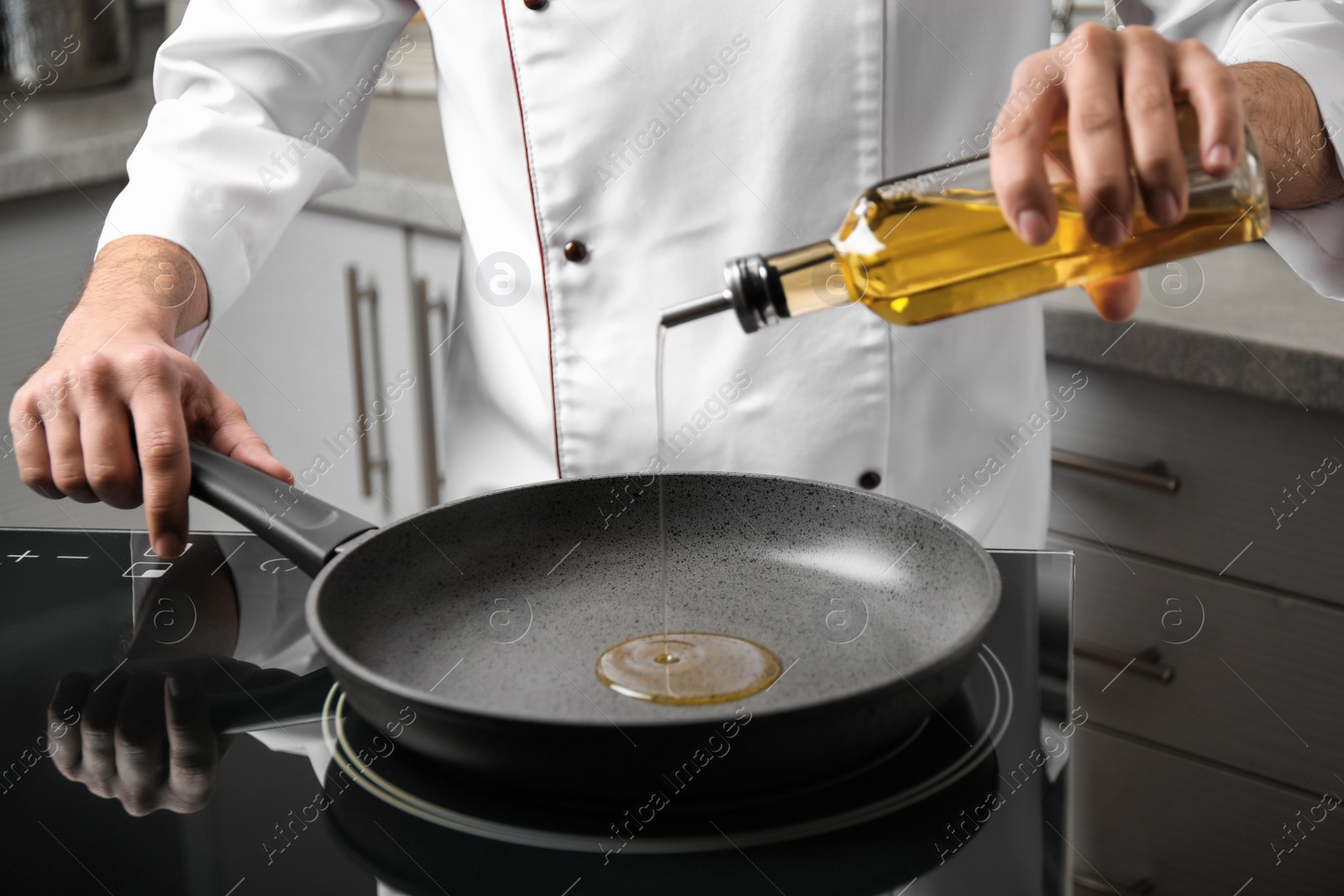 Photo of Man pouring cooking oil from bottle into frying pan, closeup