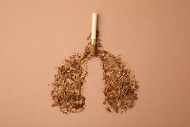 Photo of No smoking concept. Lungs made of dry tobacco and cigarette on brown background, flat lay