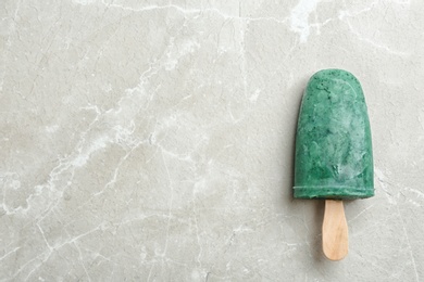 Photo of Delicious spirulina popsicle on grey background, top view. Space for text