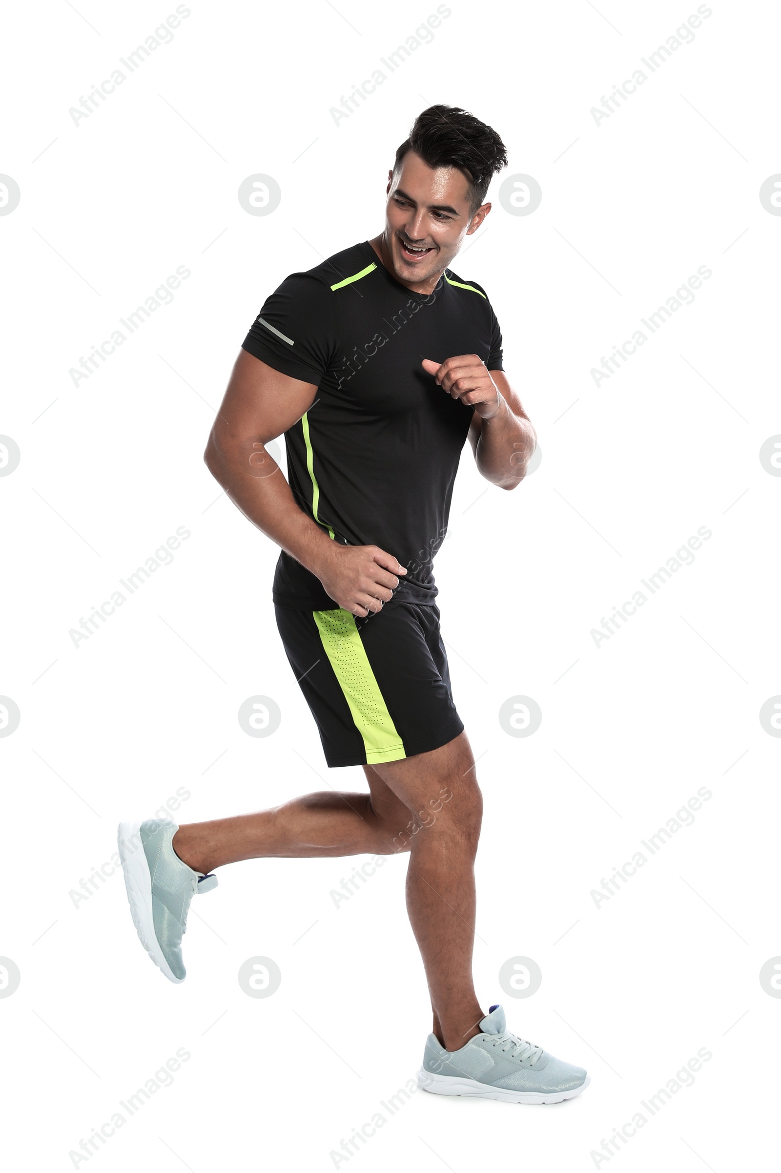 Photo of Sporty young man running on white background