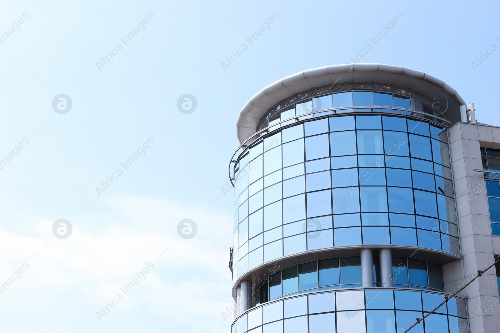 Photo of Building with tinted windows, outdoors. Modern architectural design