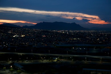 Picturesque view of city and mountains in evening