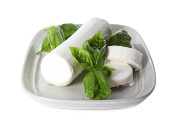 Photo of Delicious goat cheese with basil on white background