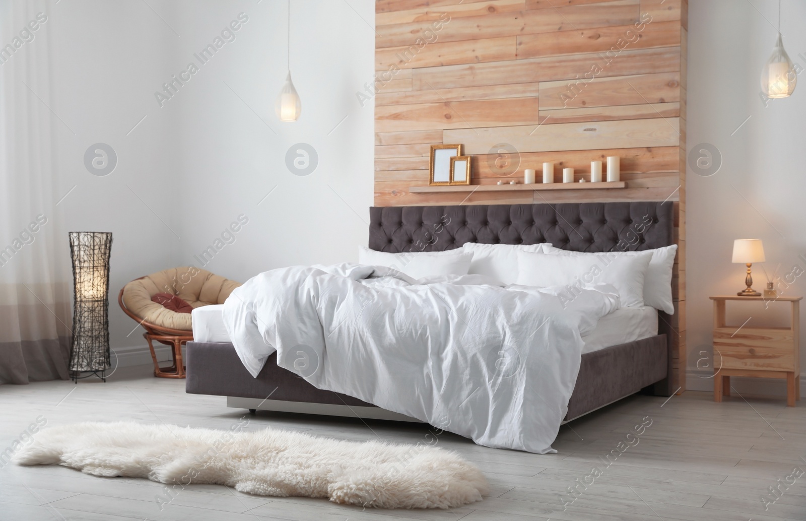 Photo of Large comfortable bed in stylish room. Modern interior design