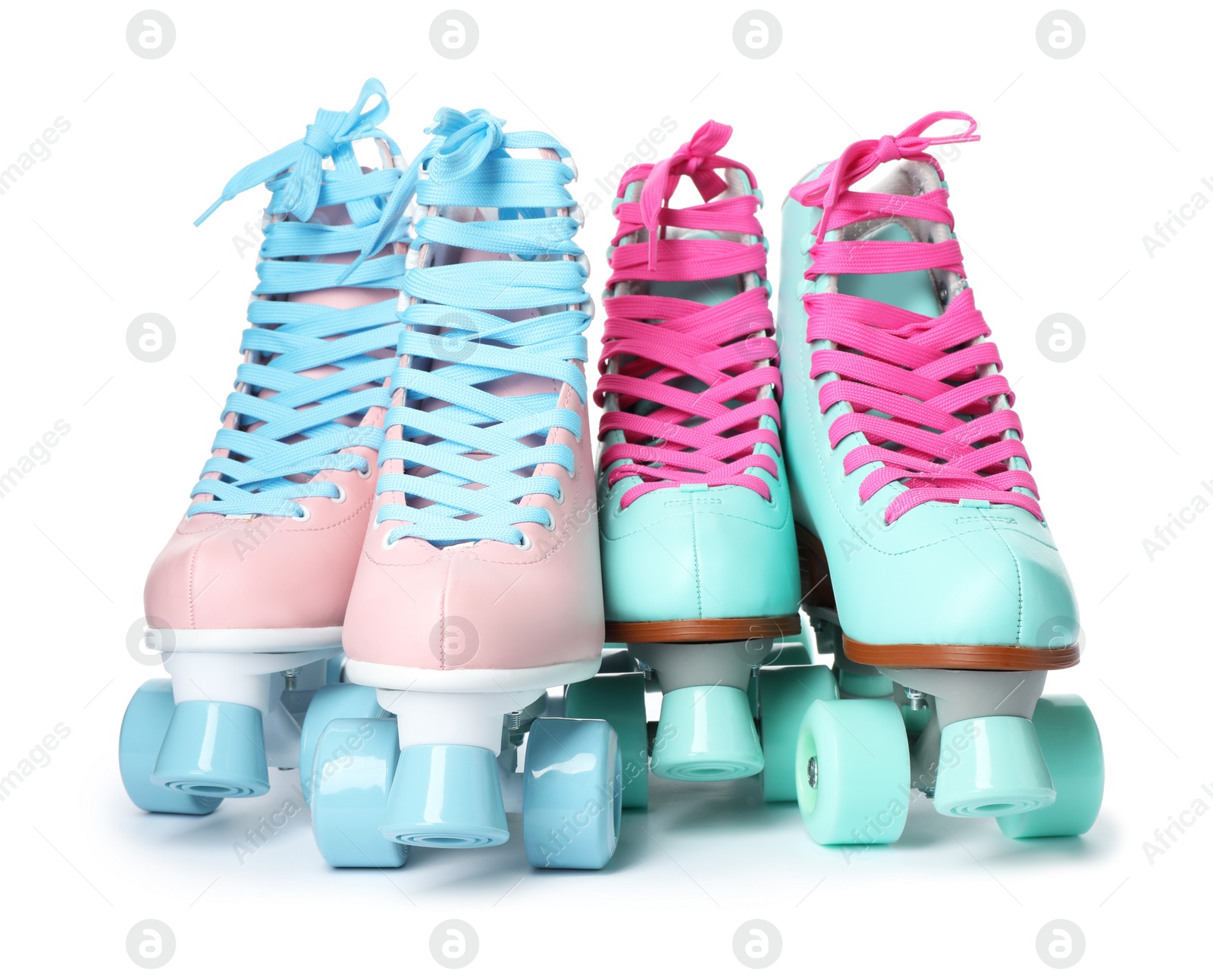 Photo of Pairs of bright stylish roller skates on white background