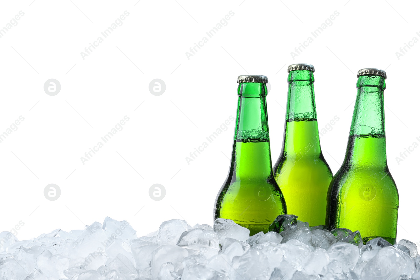 Photo of Bottles of beer on ice cubes against white background