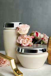 Photo of Hair care cosmetic products and beautiful flowers on tray