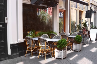 Photo of Chairs and tables near cafe on city street