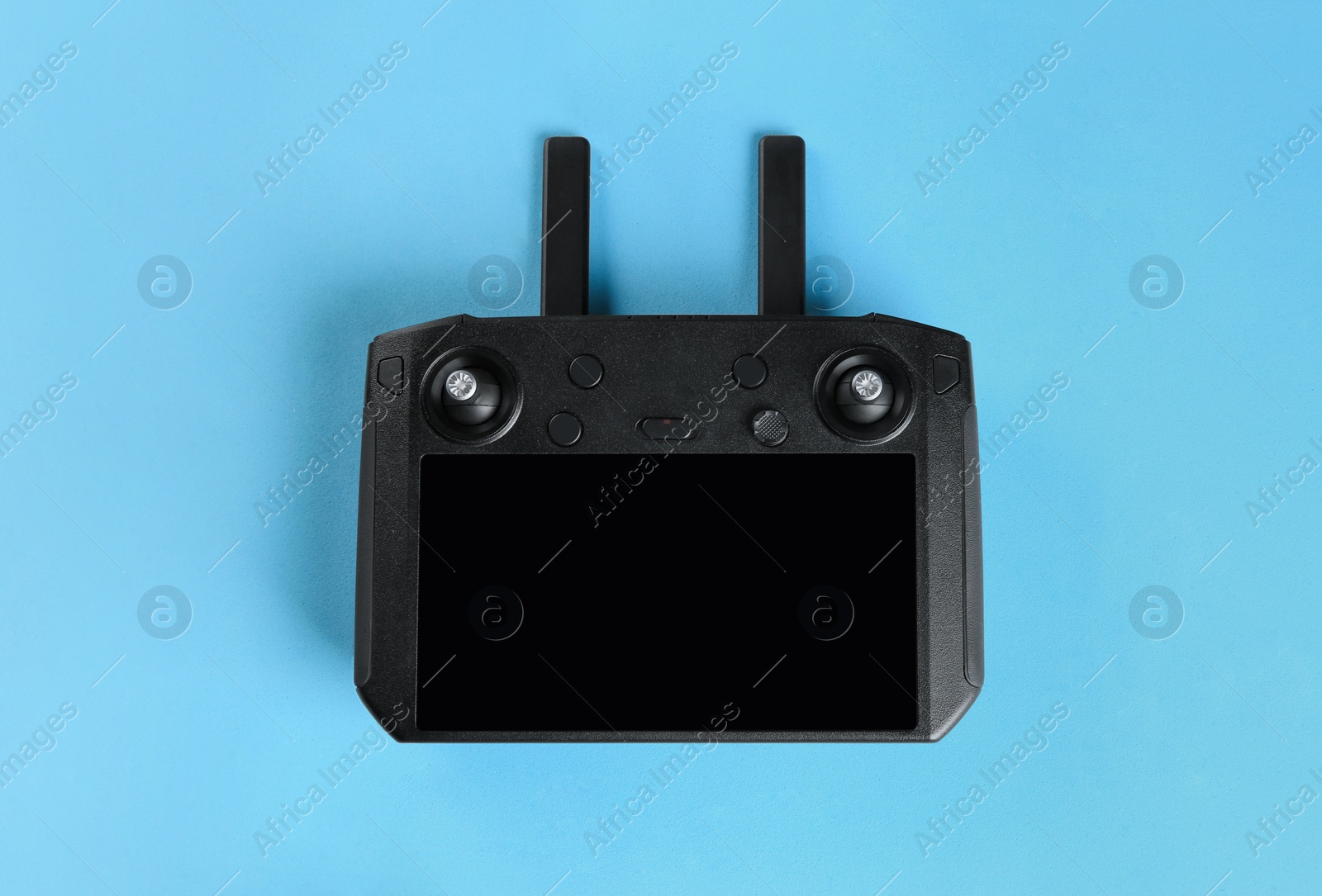 Photo of New modern drone controller on blue background, top view