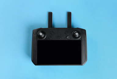 Photo of New modern drone controller on blue background, top view