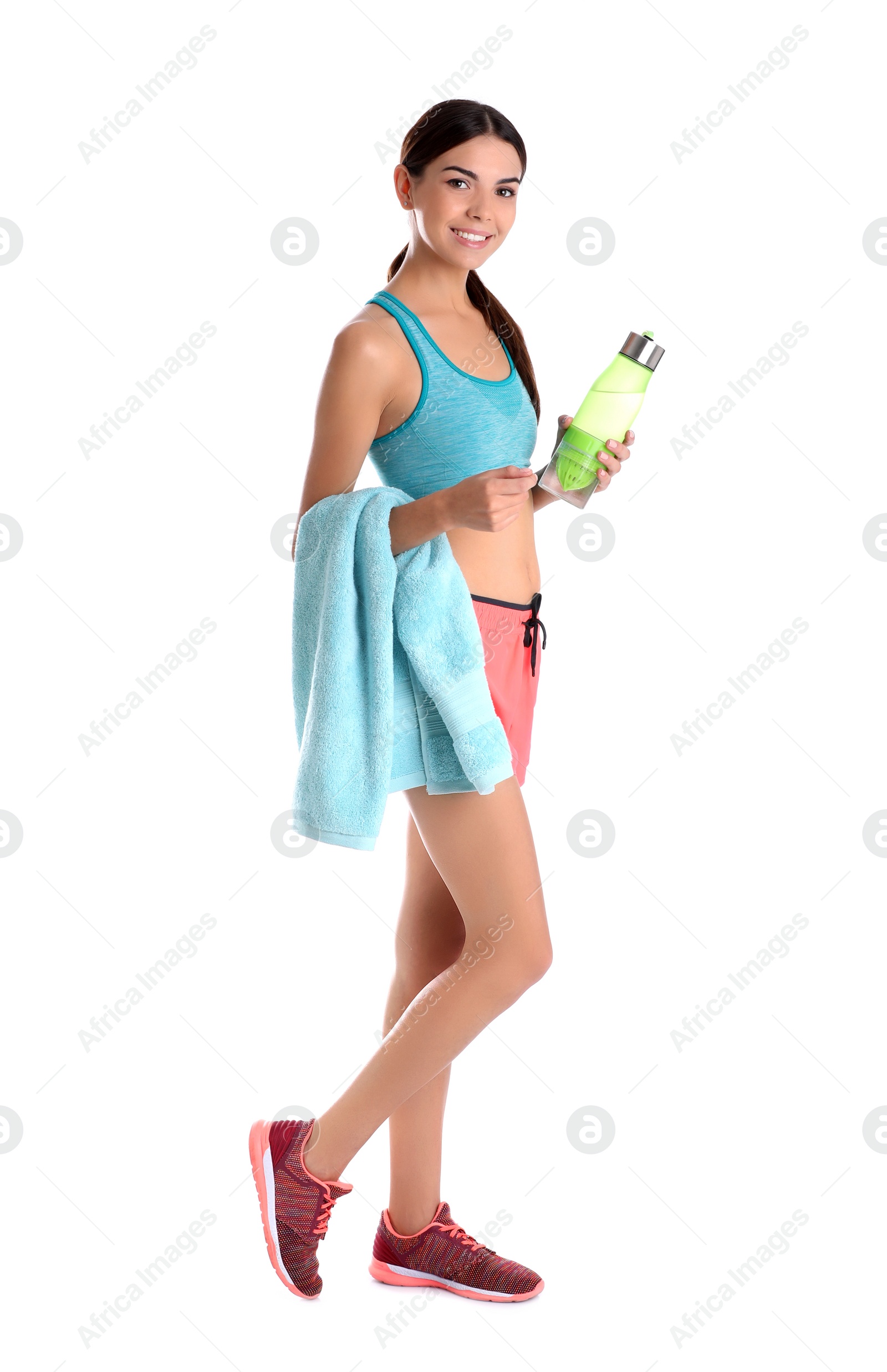 Photo of Beautiful young woman in sportswear with towel and bottle of water on white background