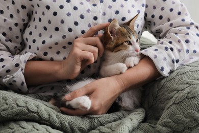 Photo of Woman with cute kitten at home, closeup