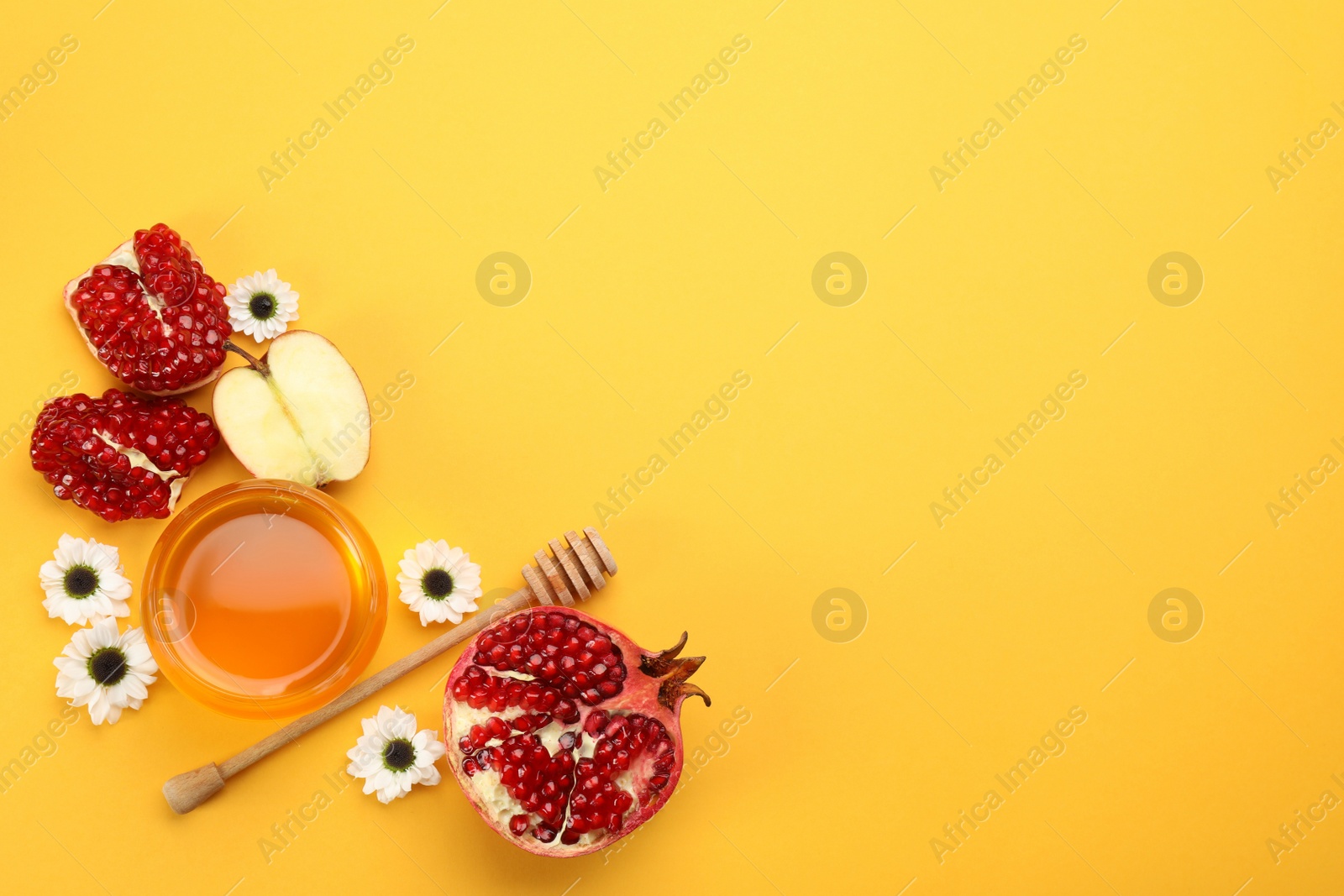 Photo of Flat lay composition with Rosh Hashanah holiday attributes on yellow background. Space for text