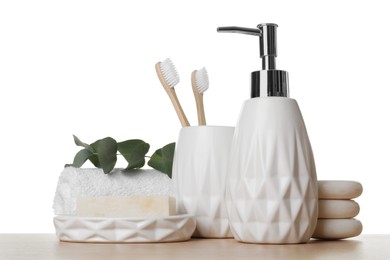 Bath accessories. Different personal care products and eucalyptus branch on wooden table against white background