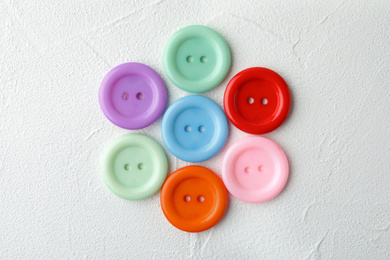 Photo of Many sewing buttons on white background, top view