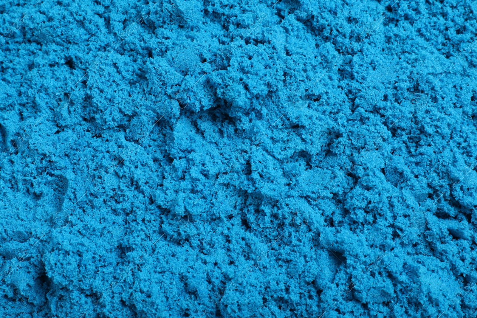 Photo of Blue kinetic sand as background, closeup view