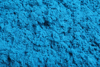 Blue kinetic sand as background, closeup view