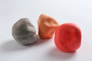 Photo of Different color play dough on white background