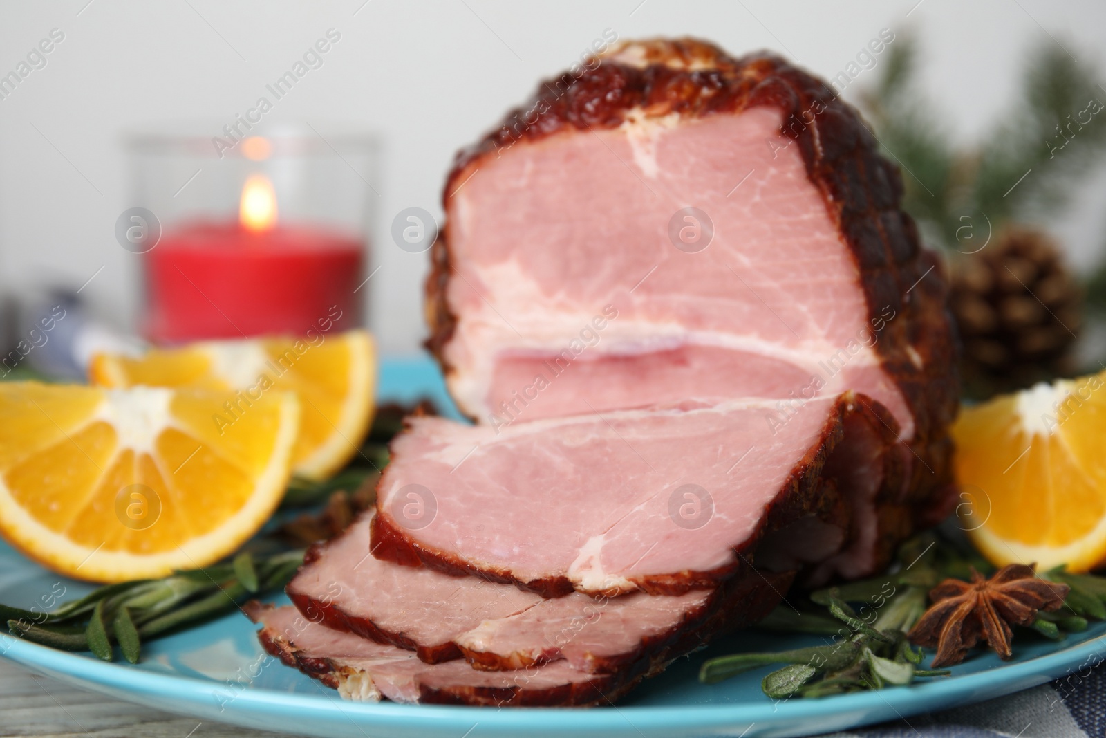 Photo of Plate with delicious ham, rosemary and orange on white table. Christmas dinner