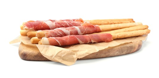 Delicious grissini sticks with prosciutto on white background