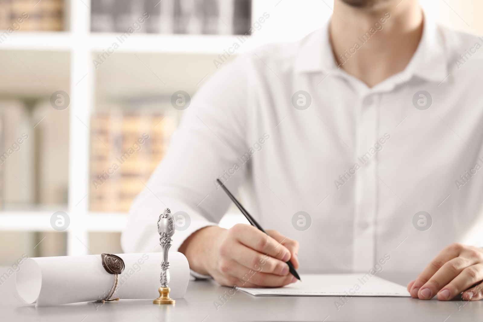 Photo of Male notary working with documents at table indoors, closeup