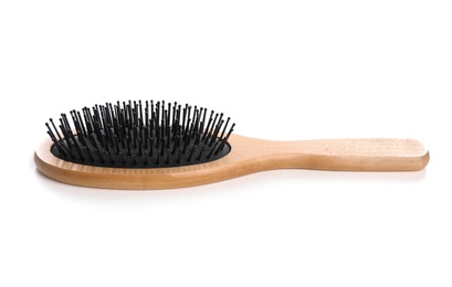 Photo of New wooden hair brush on white background