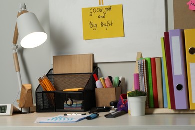 Photo of Business process planning and optimization. Workplace with lamp and different stationery on table