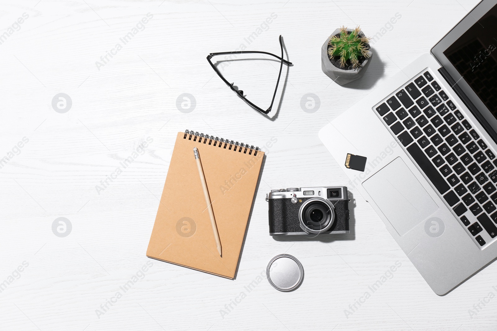 Photo of Flat lay composition with equipment for professional photographer on wooden background. Space for text
