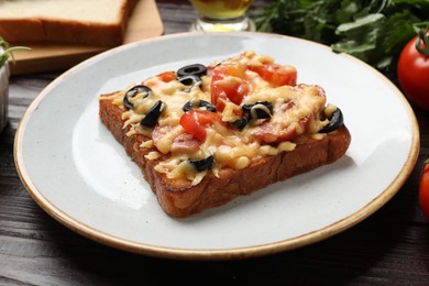 Photo of Tasty pizza toast on wooden table, closeup