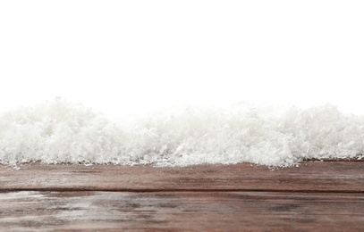 Photo of Snow on wooden surface against white background. Christmas season