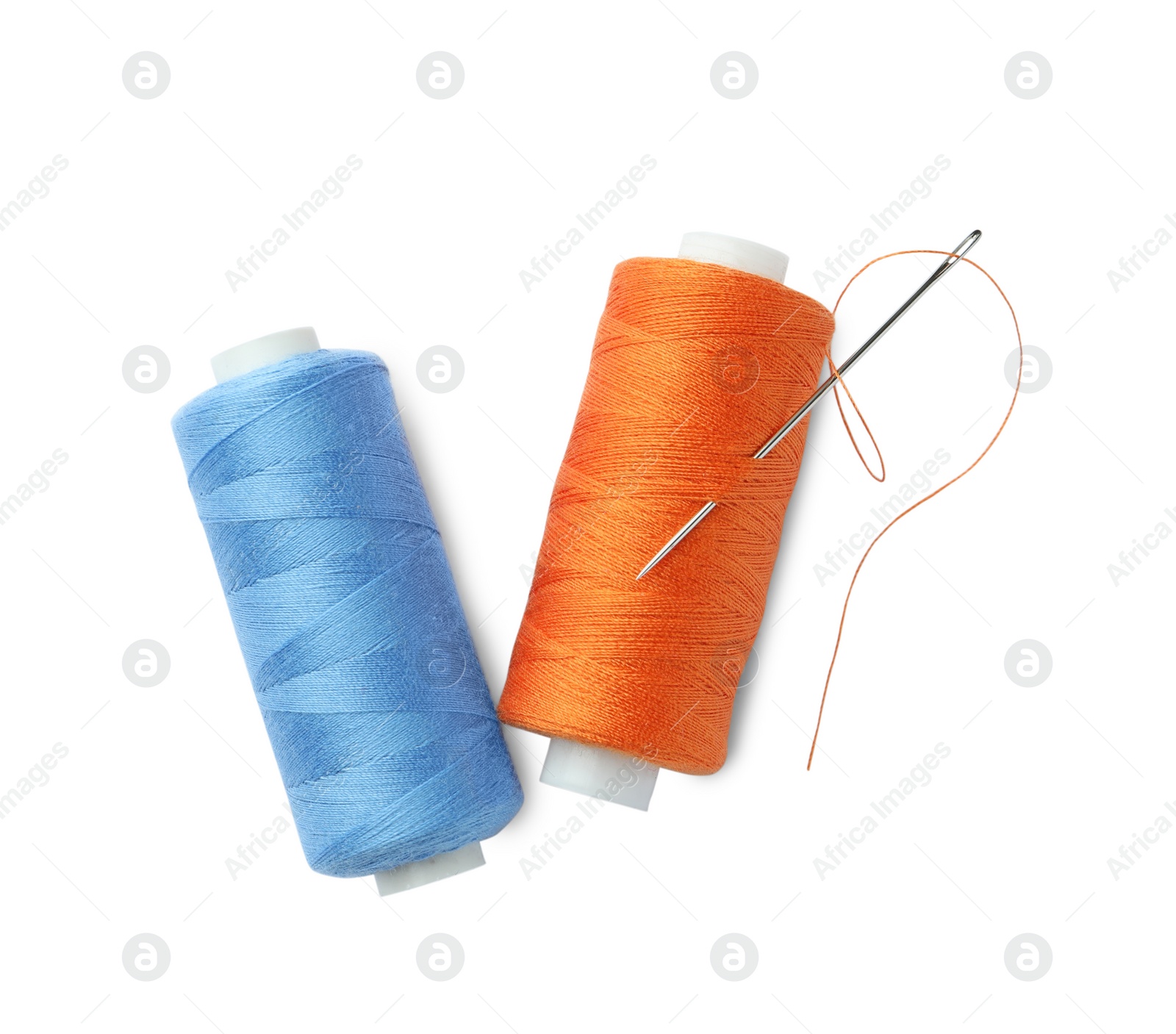 Photo of Different colorful sewing threads and needle on white background, top view