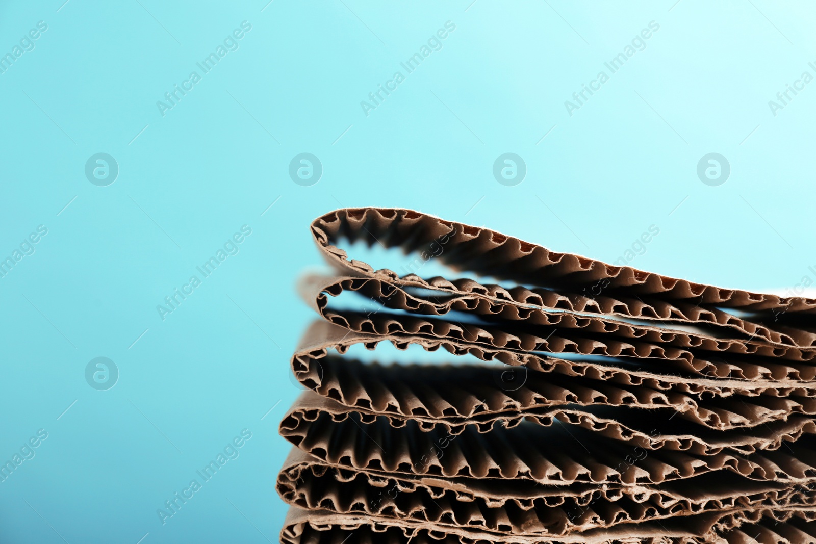 Photo of Stack of cardboard for recycling on color background. Space for text