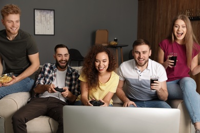 Emotional friends playing video games at home