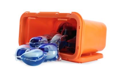 Photo of Overturned box with laundry capsules on white background