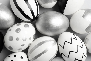 Photo of Painted Easter eggs on table, top view