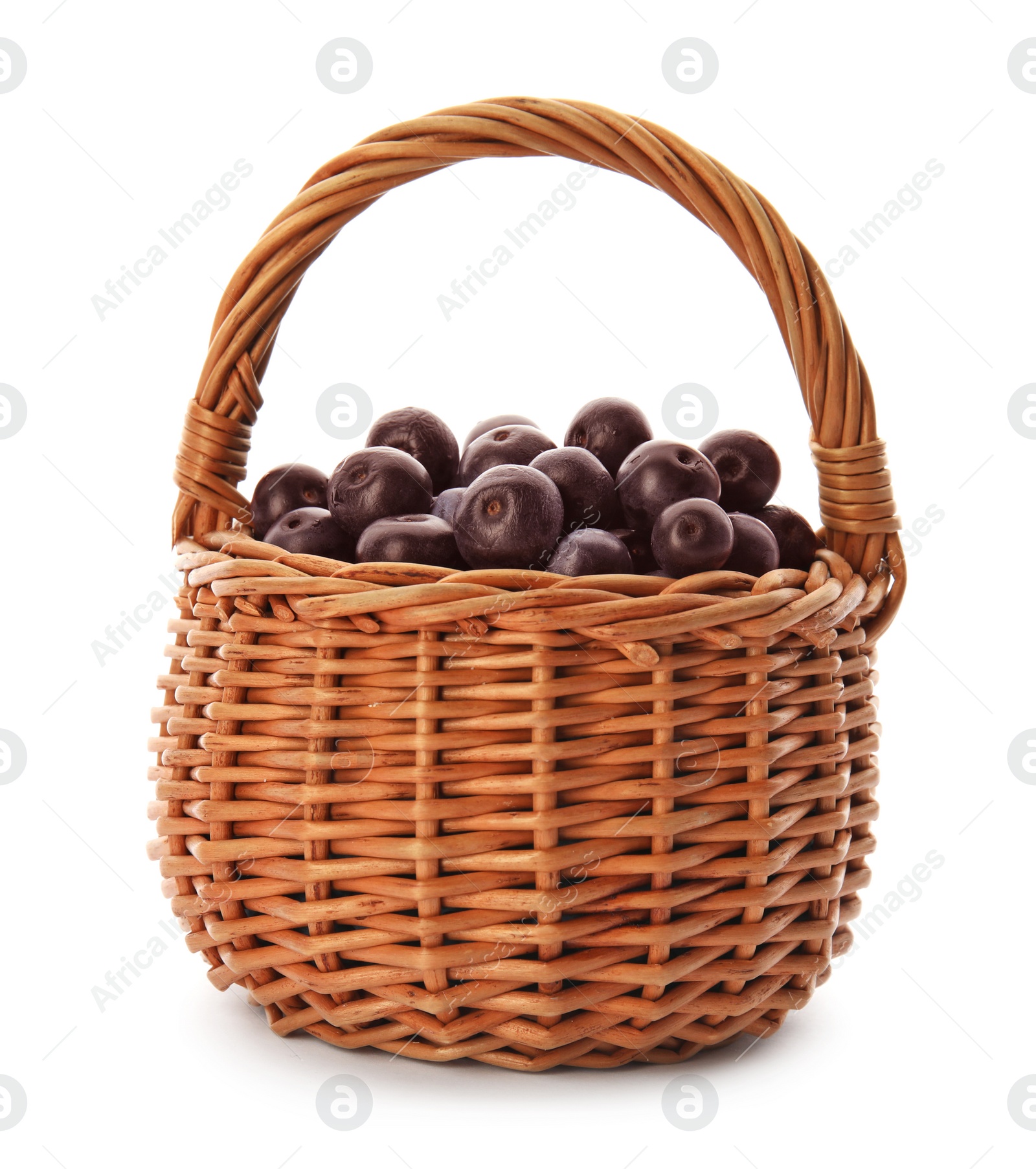 Photo of Wicker basket with fresh acai berries on white background