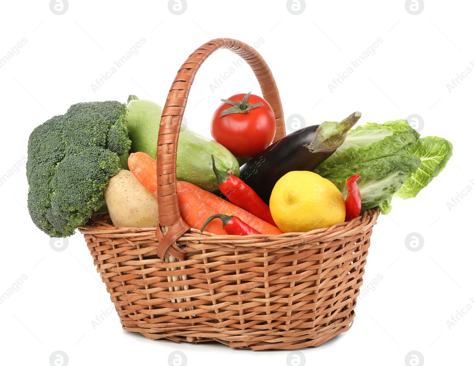 Photo of Fresh ripe vegetables and fruit in wicker basket on white background