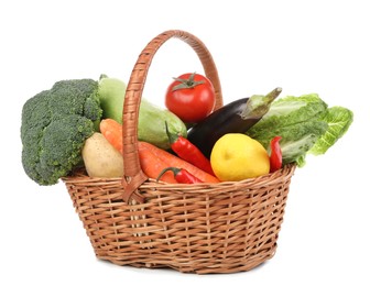 Photo of Fresh ripe vegetables and fruit in wicker basket on white background