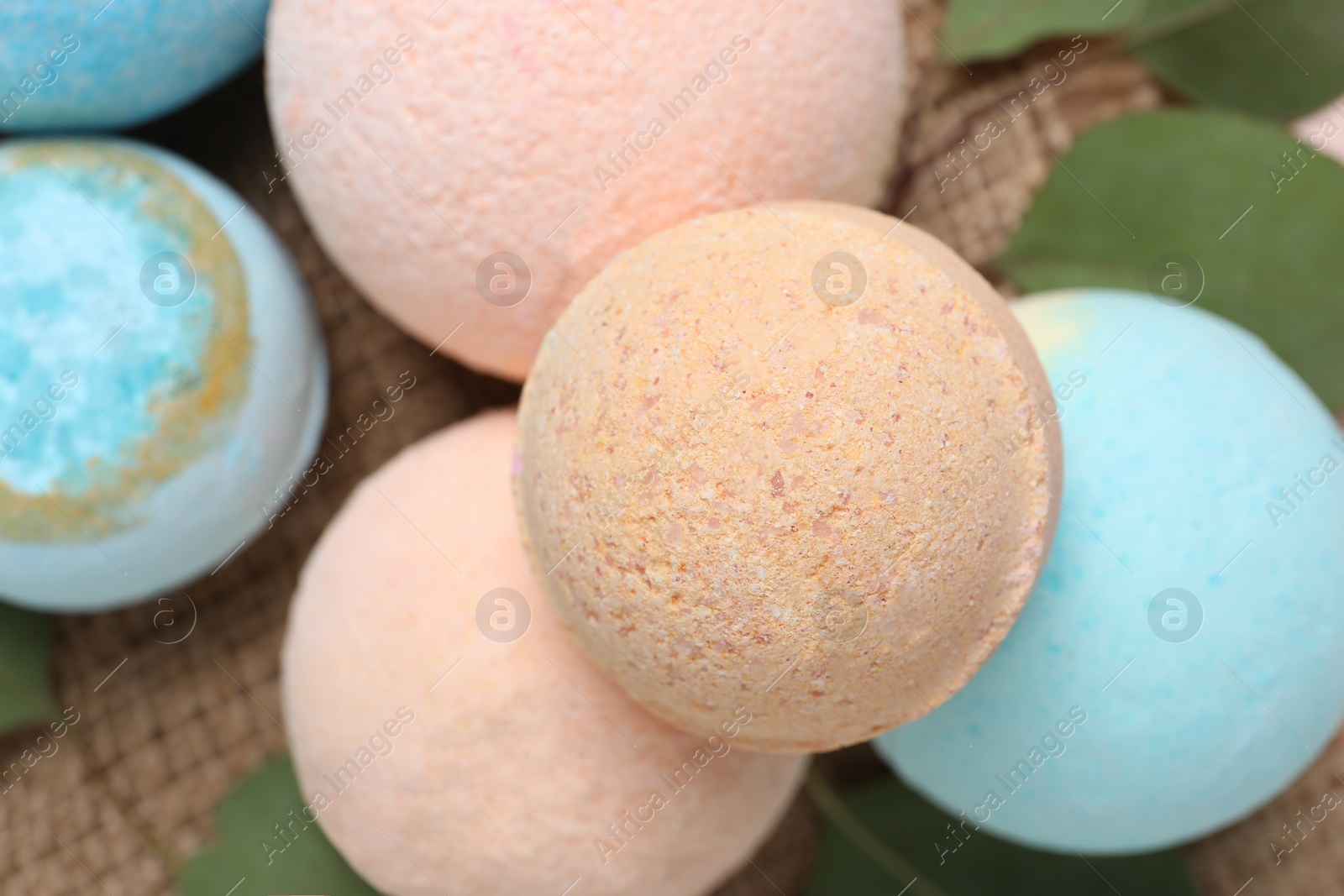 Photo of Bath bombs and eucalyptus leaves on burlap fabric, above view