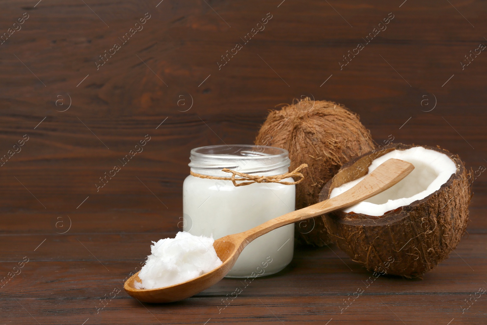 Photo of Composition with organic coconut oil on wooden table. Healthy cooking