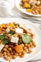 Plate with delicious fresh chickpea salad on table