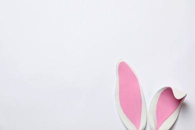 Photo of Funny Easter bunny ears on white background, top view