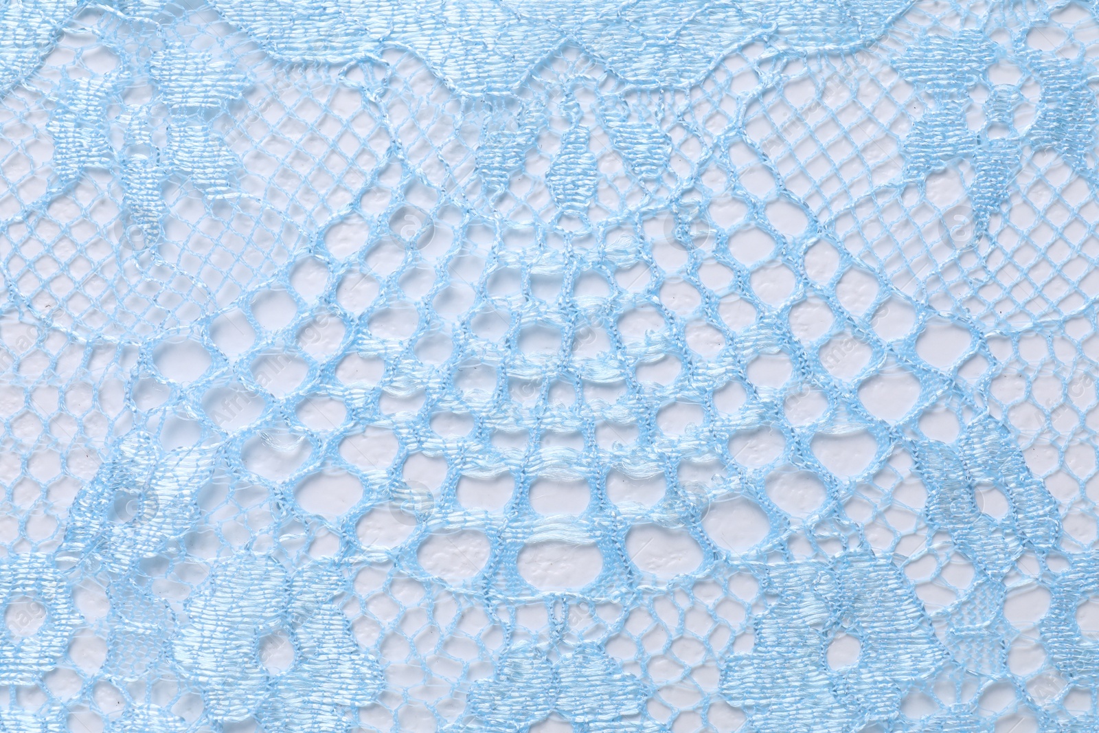 Photo of Light blue lace as background, top view