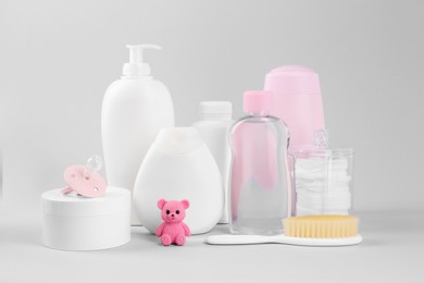 Different baby care products and accessories on light grey background