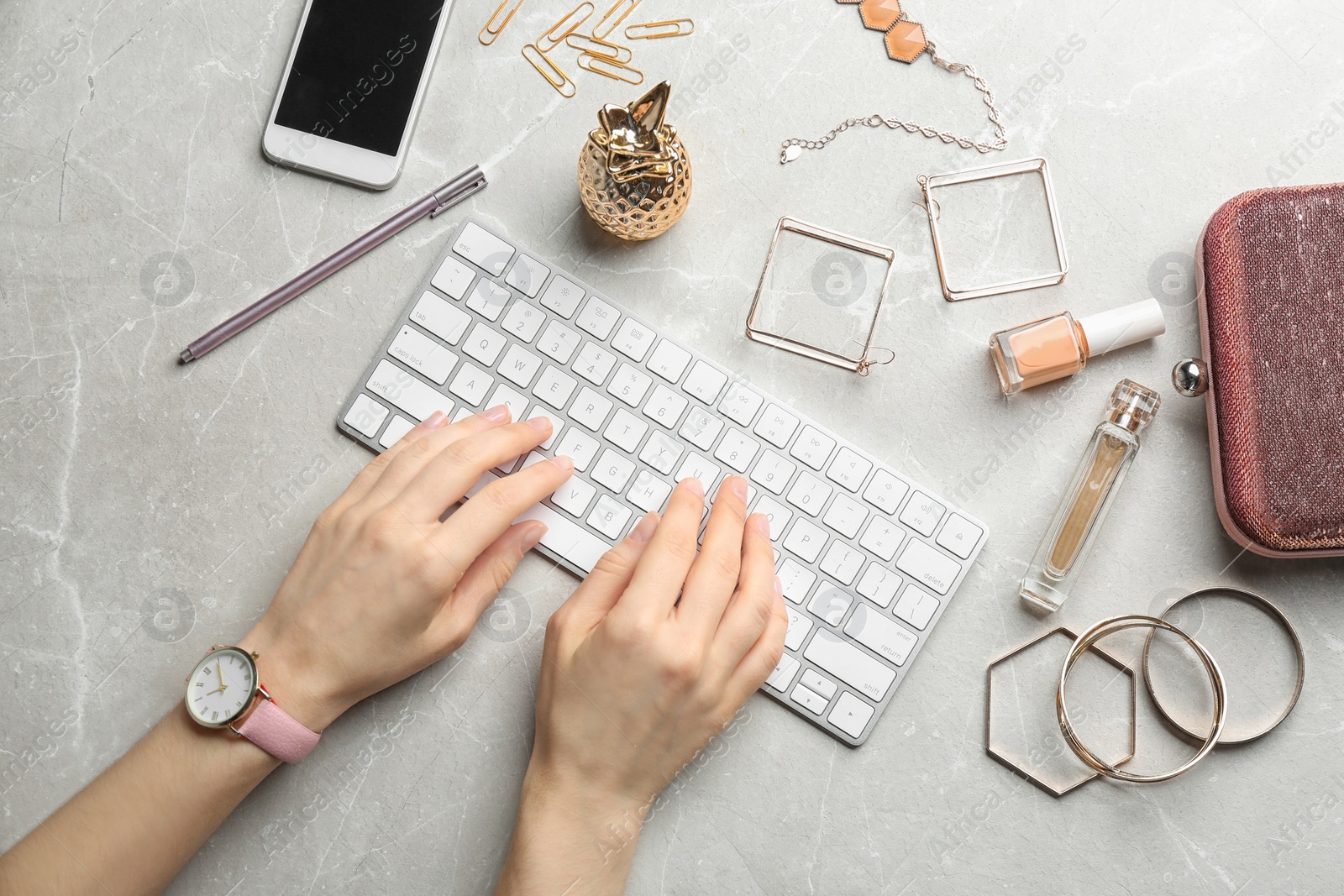 Photo of Blogger typing on keyboard at workplace, top view